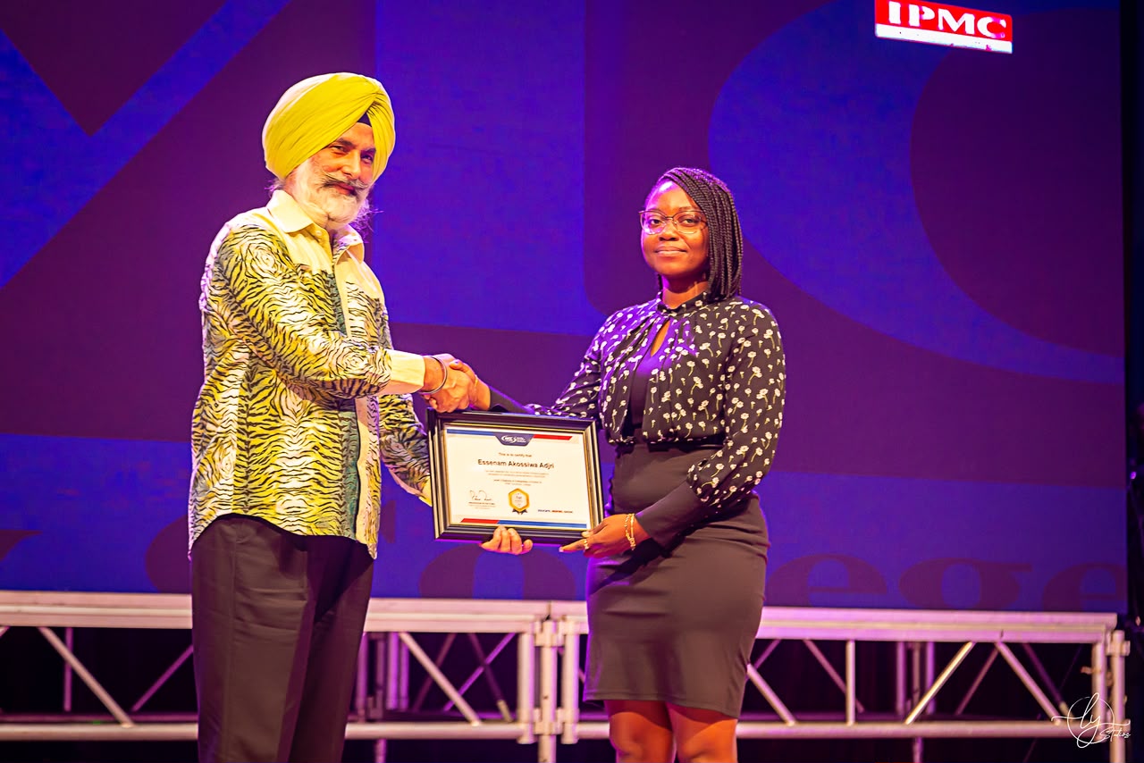 IPMC's founder handing a certificate to a graduate on stage