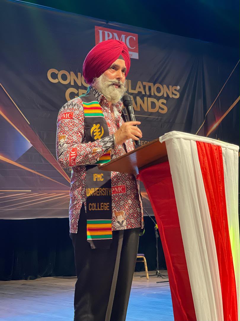 IPMC's founder addressing a graduating class from the podium