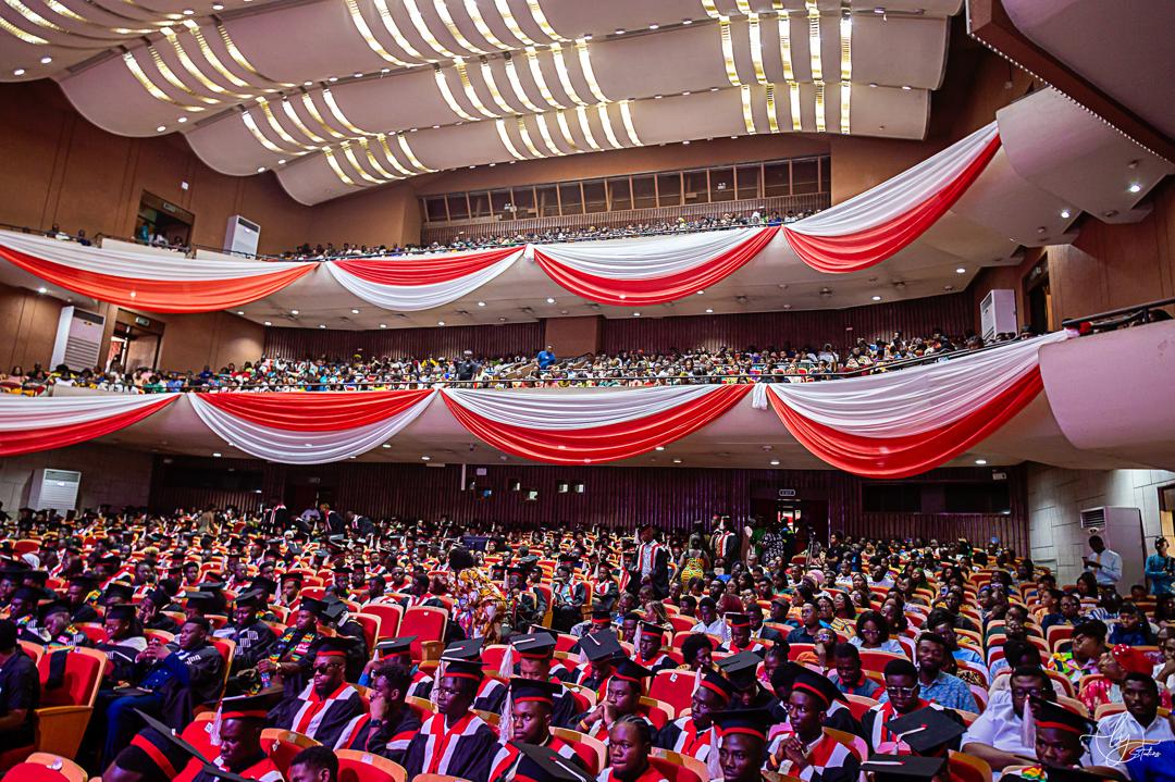 A packed auditorium of IPMC graduands in caps and gowns